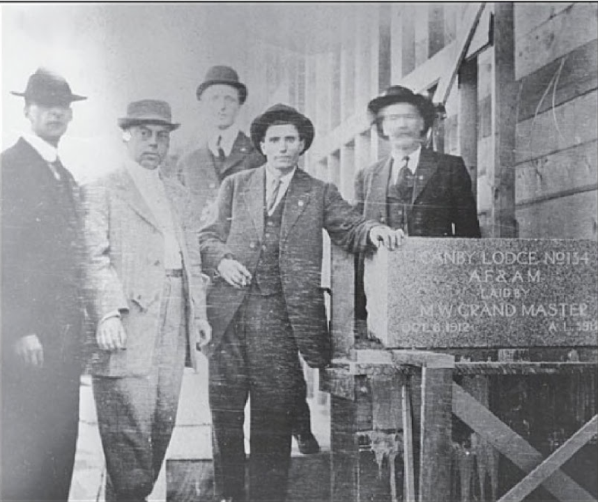 Ora Slyter, fourth from left, touching sign.