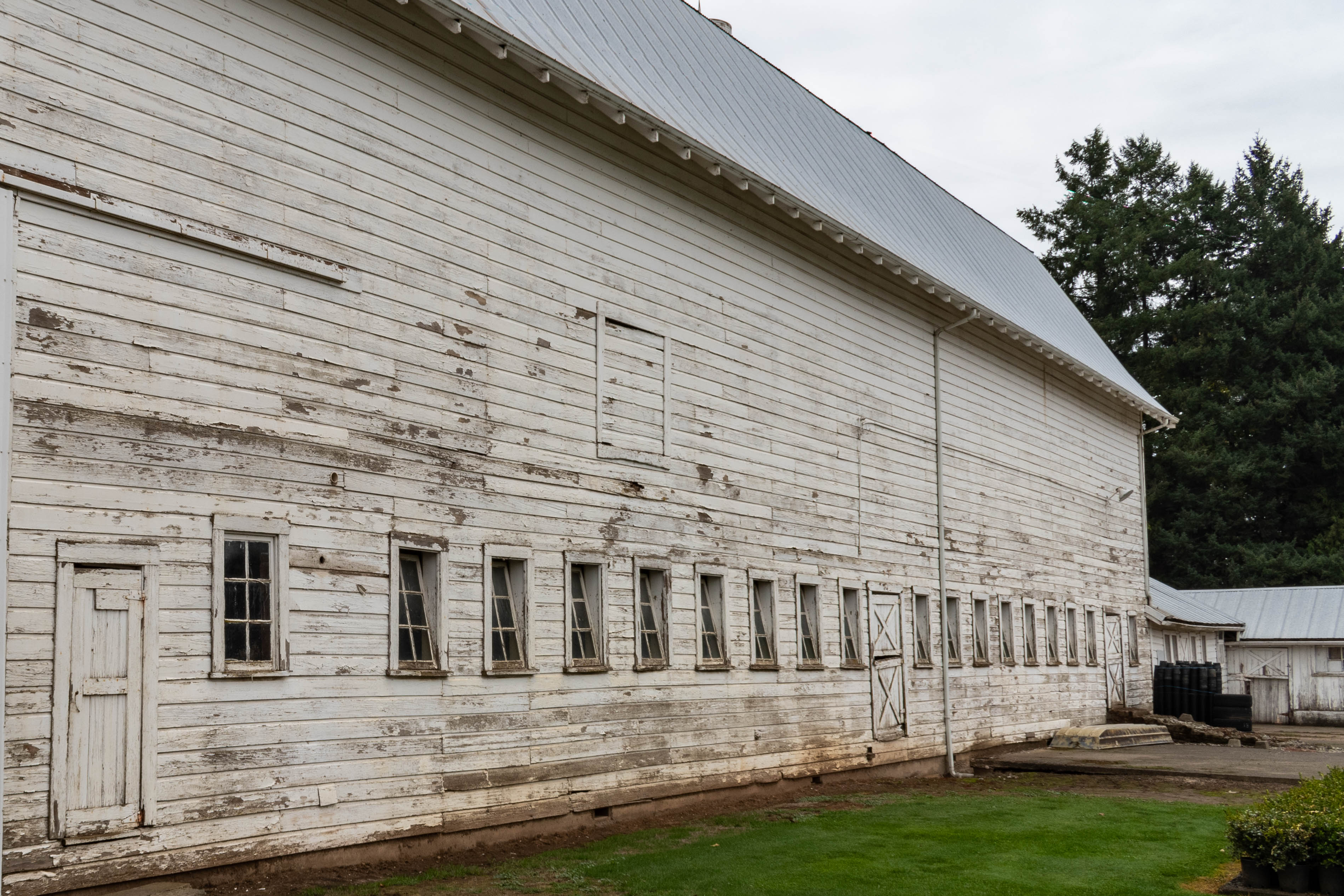 The east side of the barn has a row of louvered windows.